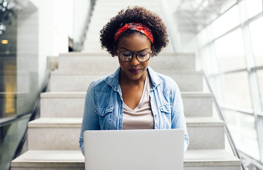 student-with-laptop-on-steps